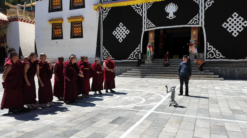 Gadan Dongzhulin: The Converted Monastery in the Mountains of Yunnan gadan dongzhulin monks with robot dog